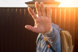 stock photo of a man blocking his face with his hand